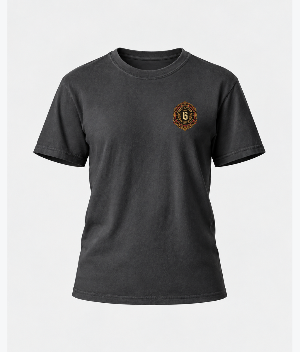 Front product view of the graphite Buchner's Bierhalle Oktoberfest 2026 commemorative T-shirt with a small stylized Buchner's crest on the left chest.