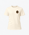 Front product view of the ivory Buchner's Bierhalle Oktoberfest 2026 commemorative T-shirt with a small stylized Buchner's crest on the left chest.