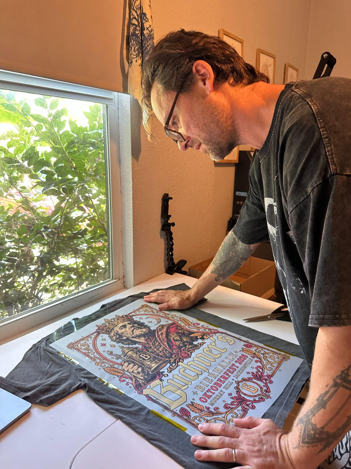 Day Dreams pressing a large Oktoberfest king illustration onto a graphite shirt