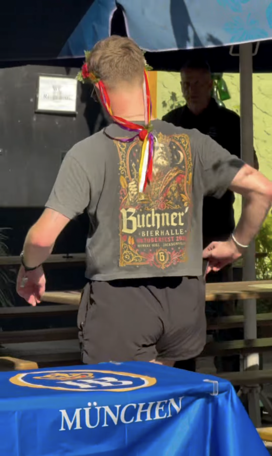 Customized cropped Buchner's Bierhalle shirt worn by a staff member