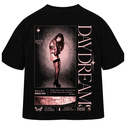 Black graphic t-shirt shown from the back, featuring a large pink and white print with a woman in lingerie, the text 'DAYDREAM' vertically, and 'AMOR FATI' at the bottom.