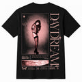 A black short-sleeve t-shirt shown from the back, featuring a large graphic print with a woman in a pink-toned portrait, vertical text reading 'DAYDREAM', and smaller decorative text and illustration elements.